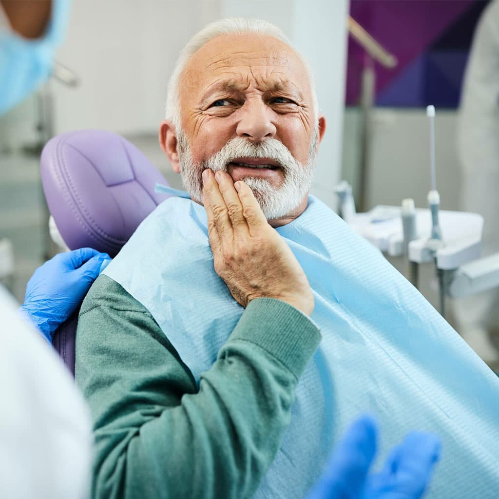 Man holding his jaw in pain